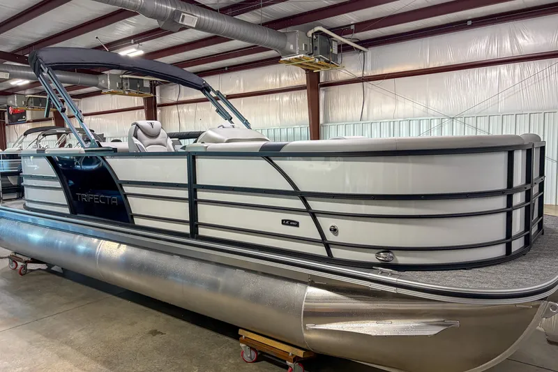 Slide: The Image of 2026 Trifecta 24RF LE pontoon boat in a warehouse setting. - 3