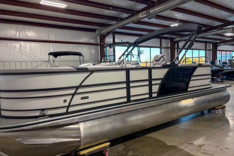 Slide: The Image of 2026 Trifecta 24RF LE pontoon boat in a showroom, showcasing sleek design and modern features. - 4