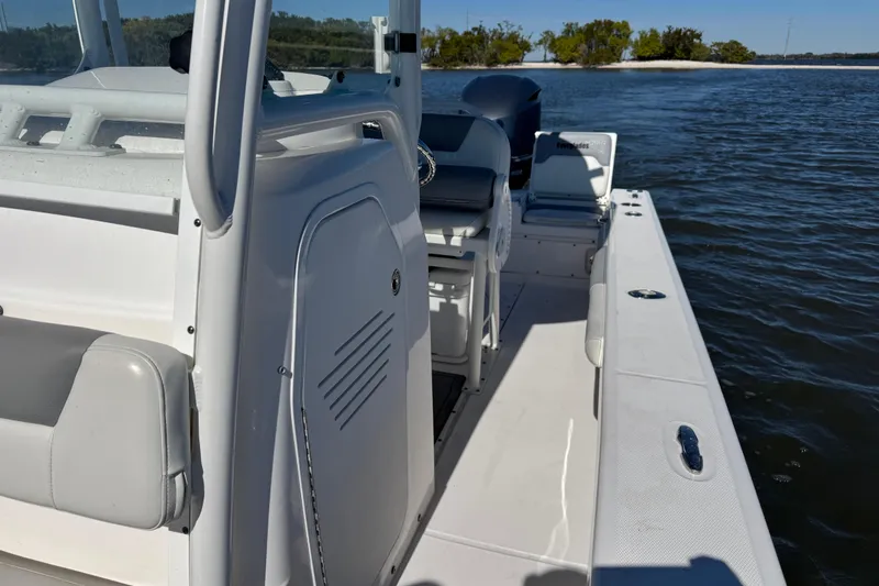 Slide: The Image of 2017 Everglades 243 Center Console boat on calm water, showcasing interior seating and console. - 15