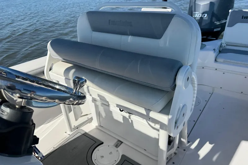 Slide: The Image of 2017 Everglades 243 Center Console boat interior with steering wheel and seating. - 16