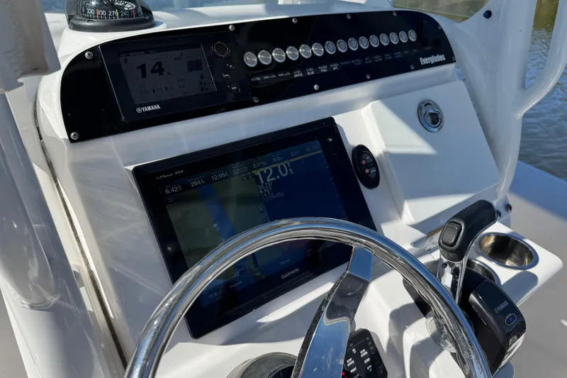 Slide: The Image of 2017 Everglades 243 Center Console dashboard with navigation and control systems. - 17
