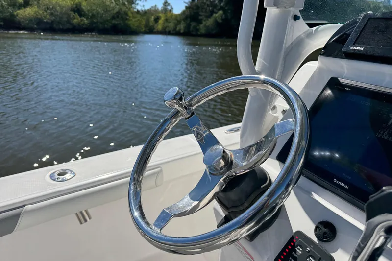 Slide: The Image of Steering wheel of a 2017 Everglades 243 Center Console boat on a sunny day. - 18