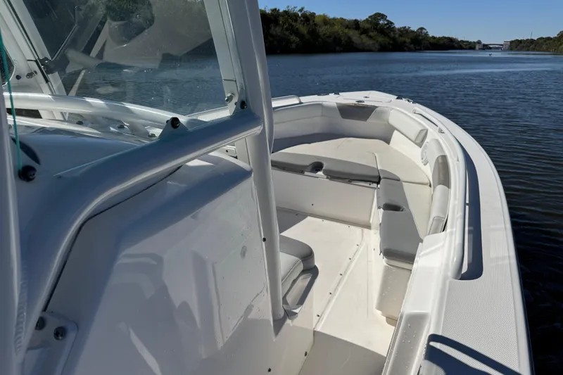 Slide: The Image of 2017 Everglades 243 Center Console boat on calm river, featuring spacious seating. - 20