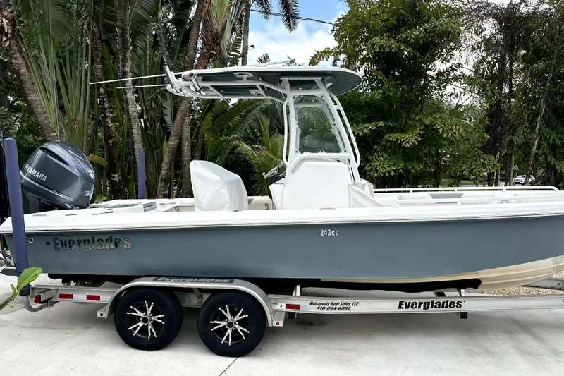 Slide: The Image of 2017 Everglades 243 Center Console boat on trailer, surrounded by lush greenery. - 25