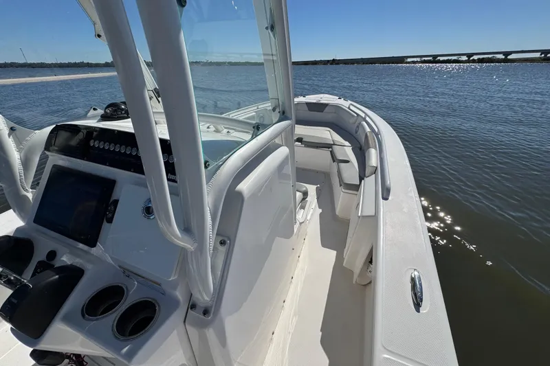 Slide: The Image of 2017 Everglades 243 Center Console boat on calm water, showcasing helm and seating area. - 5