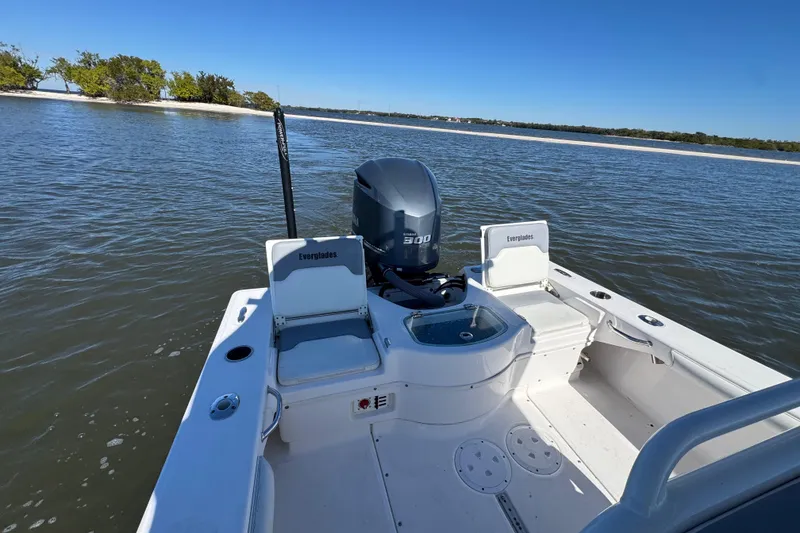Slide: The Image of 2017 Everglades 243 Center Console boat on calm water, featuring a powerful engine. - 8
