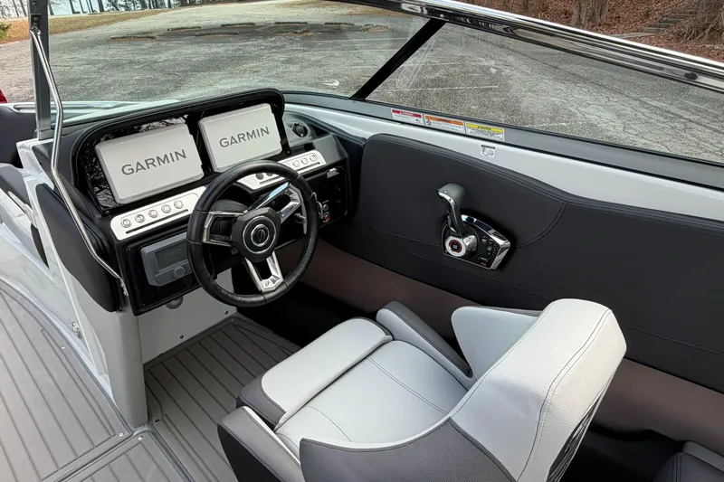 Slide: The Image of 2026 Crownline Eclipse E255 boat cockpit with Garmin displays and modern steering wheel. - 19
