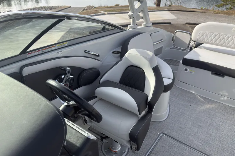 Slide: The Image of 2026 Crownline Eclipse E255 boat interior with modern seating and steering wheel. - 9