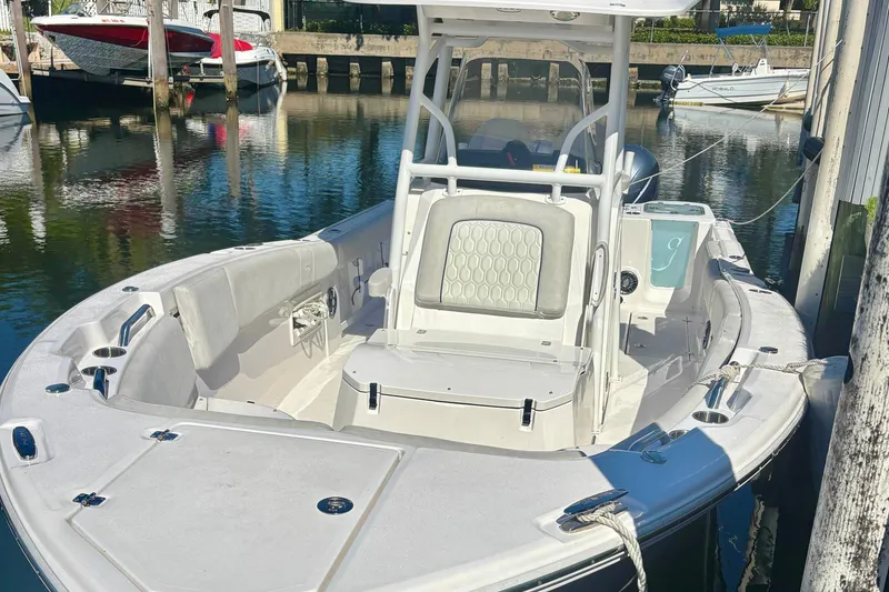 The Image of 2023 Sea Fox 268 Commander boat docked in a marina, showcasing spacious seating and sleek design. - 0