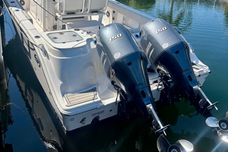 Slide: The Image of 2023 Sea Fox 268 Commander with dual Yamaha 150 engines docked on water. - 16