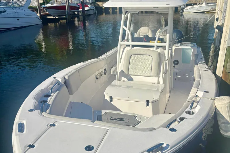 Slide: The Image of 2023 Sea Fox 268 Commander boat docked, showcasing spacious seating and sleek design. - 2
