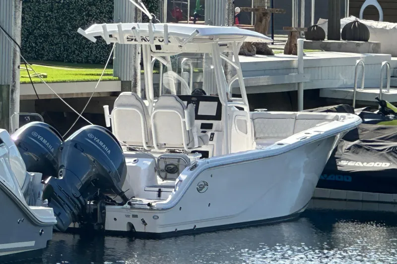 Slide: The Image of 2023 Sea Fox 268 Commander boat docked with twin Yamaha engines. - 22