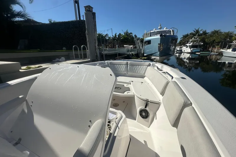Slide: The Image of 2023 Sea Fox 268 Commander boat docked in a sunny marina setting. - 27