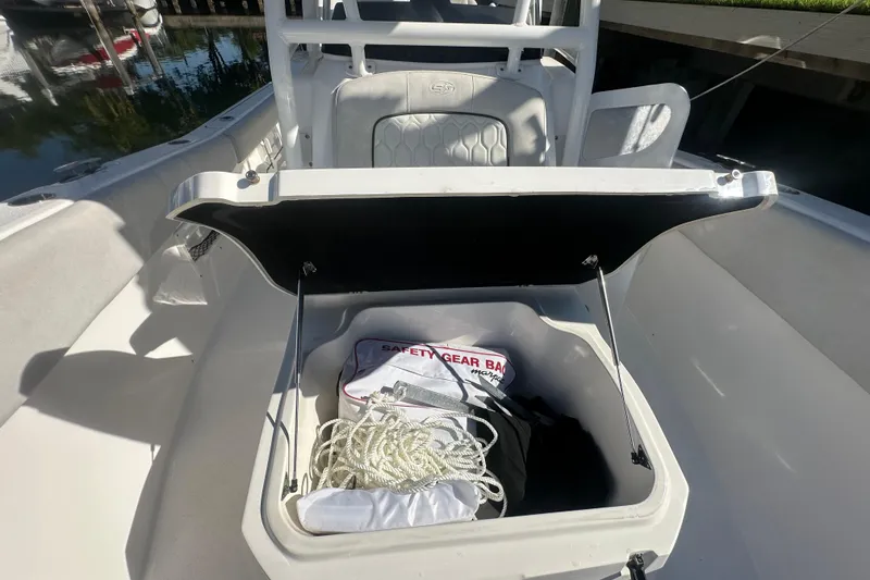 Slide: The Image of Open storage compartment on 2023 Sea Fox 268 Commander boat with safety gear and rope. - 28