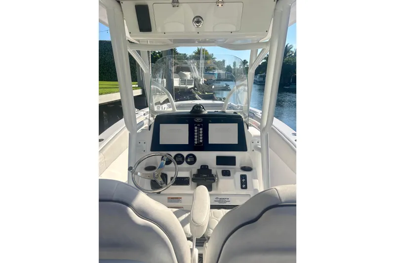 Slide: The Image of 2023 Sea Fox 268 Commander boat interior with cushioned seating and cup holders. - 4