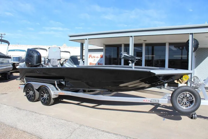 The Image of 2026 Excel EX 203 boat on trailer, parked outside a dealership. - 1