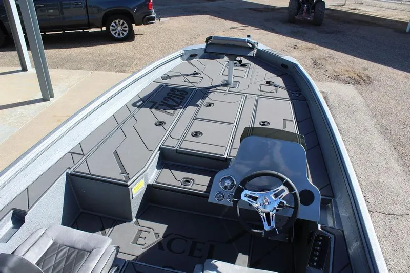 Slide: The Image of 2026 Excel EX 203 boat interior with steering wheel and spacious deck layout. - 13