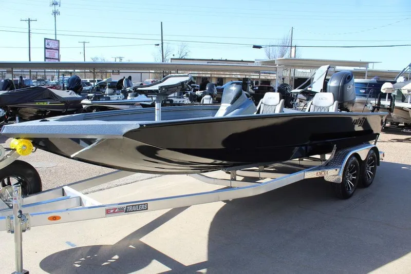 Slide: The Image of 2026 Excel EX 203 boat on trailer, sleek black design, parked outdoors. - 5