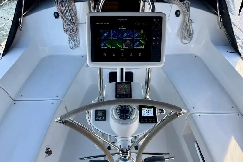 Slide: The Image of Cockpit of DUET with Bow Thruster Joystick,  folding steering wheel and Raymarine  Axiom navigation equipment. - 10
