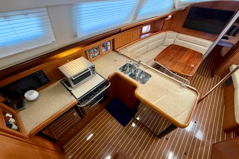 Slide: The Image of Luxurious 2007 Hunter 44 Deck Salon interior with modern kitchen and cozy seating area. - 21
