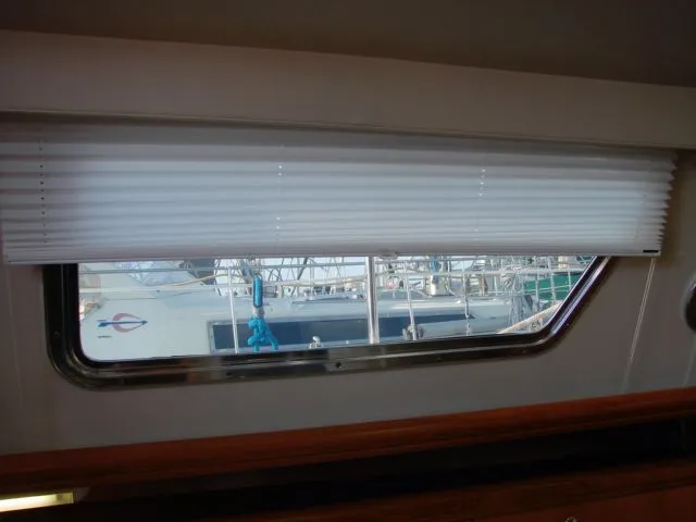 Slide: The Image of Window view from 2007 Hunter 44 Deck Salon with blind half way down. - 51