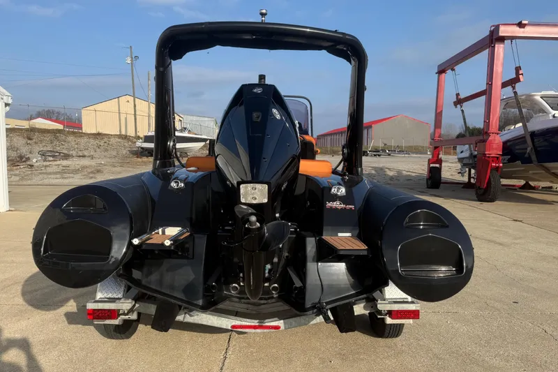 Slide: The Image of 2019 Brig Eagle 650 boat on trailer, rear view, in a marina setting. - 3