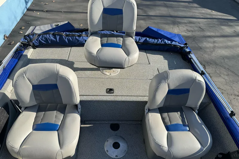 Slide: The Image of 2017 Tracker Pro Team 175 TF boat interior with three cushioned seats. - 10