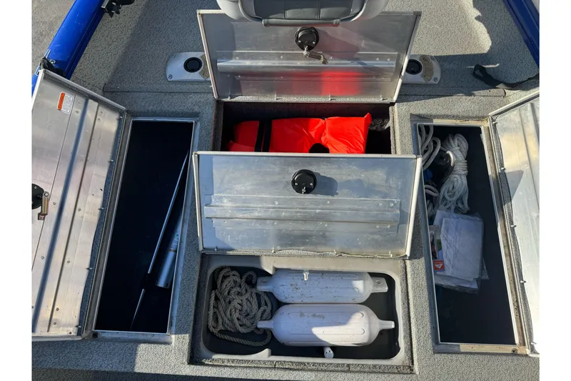 Slide: The Image of 2017 Tracker Pro Team 175 TF boat storage compartments with safety gear and ropes. - 13