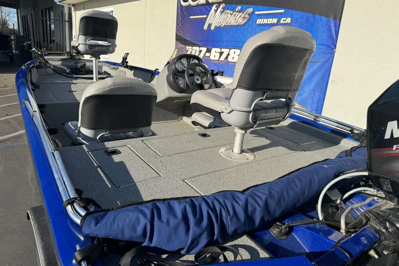 Slide: The Image of 2017 Tracker Pro Team 175 TF fishing boat with seating and motor, displayed outdoors. - 4