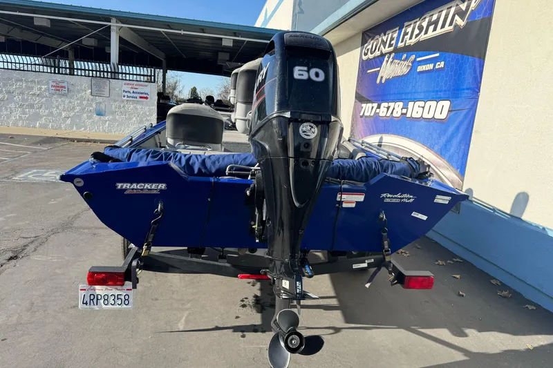 Slide: The Image of 2017 Tracker Pro Team 175 TF boat with Mercury 60 engine, parked outside a fishing store. - 6