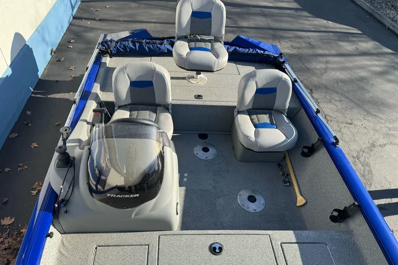 Slide: The Image of 2017 Tracker Pro Team 175 TF fishing boat with three seats and blue accents. - 9
