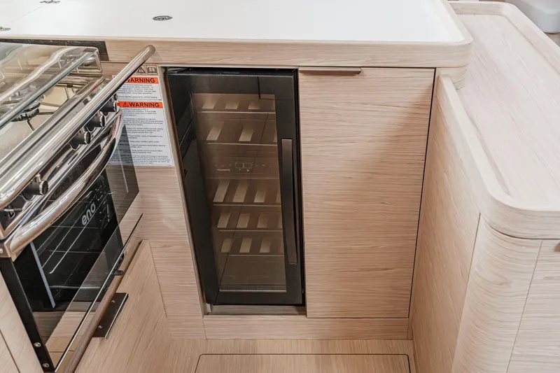 Slide: The Image of Modern kitchen area in 2022 Beneteau Oceanis Yacht 54, featuring sleek cabinetry and appliances. - 10