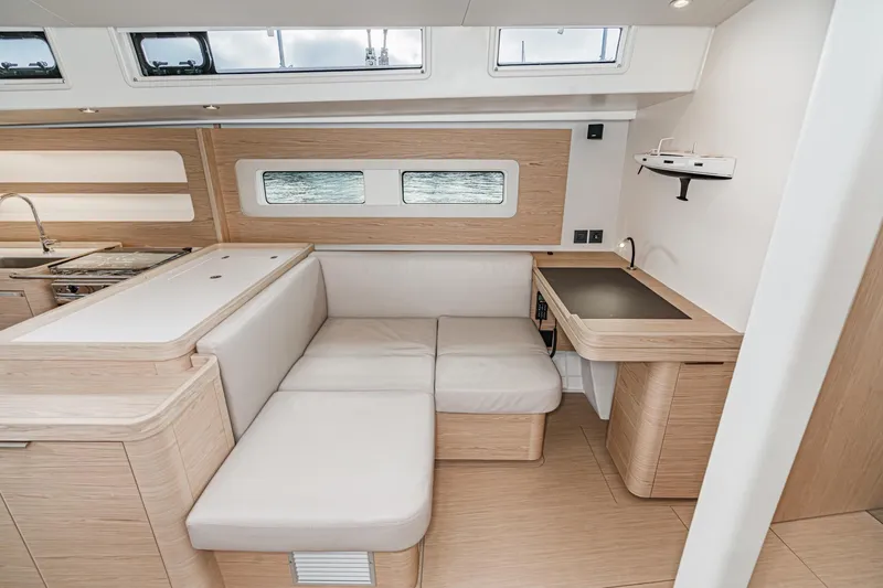 Slide: The Image of Interior of 2022 Beneteau Oceanis Yacht 54, featuring modern seating and sleek design. - 11