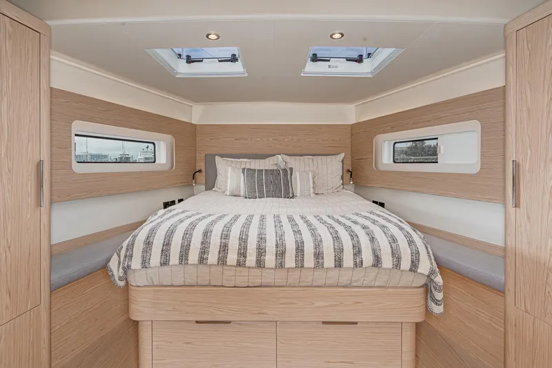 Slide: The Image of Luxurious bedroom interior of 2022 Beneteau Oceanis Yacht 54 with modern wood finish. - 14