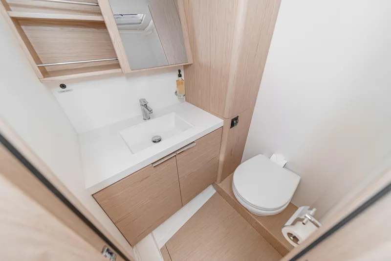 Slide: The Image of Modern bathroom in 2022 Beneteau Oceanis Yacht 54, featuring sleek sink and toilet design. - 18