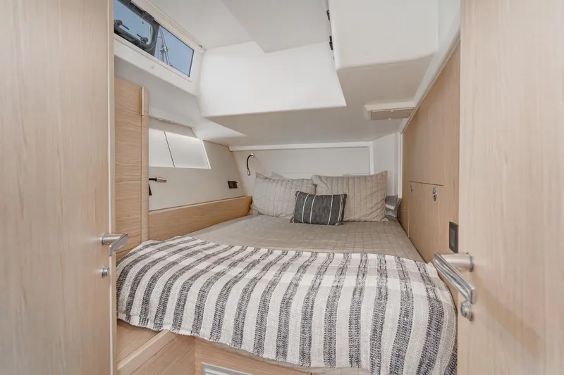 Slide: The Image of Luxurious cabin interior of 2022 Beneteau Oceanis Yacht 54 with cozy bedding. - 22