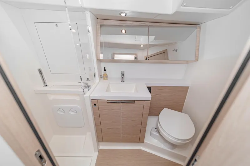 Slide: The Image of Modern bathroom in 2022 Beneteau Oceanis Yacht 54, featuring sleek fixtures and wood accents. - 24