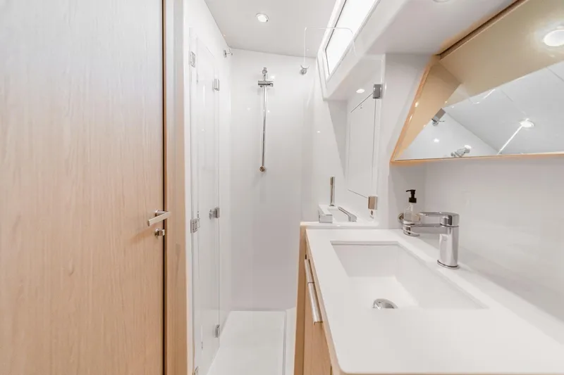 Slide: The Image of Luxurious bathroom in 2022 Beneteau Oceanis Yacht 54, featuring modern fixtures and sleek design. - 25