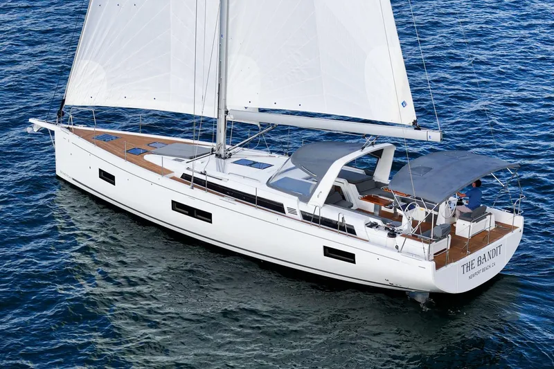 Slide: The Image of 2022 Beneteau Oceanis Yacht 54 sailing on open water, featuring sleek design and spacious deck. - 30