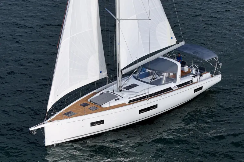 Slide: The Image of 2022 Beneteau Oceanis Yacht 54 sailing on open water, showcasing sleek design and white sails. - 31