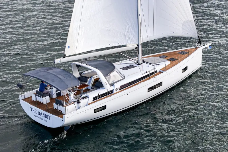 Slide: The Image of 2022 Beneteau Oceanis Yacht 54 sailing on open water, elegant design and spacious deck. - 34