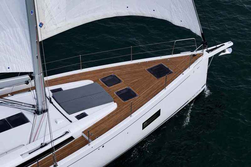 Slide: The Image of 2022 Beneteau Oceanis Yacht 54 sailing on open water, showcasing sleek design and wooden deck. - 39