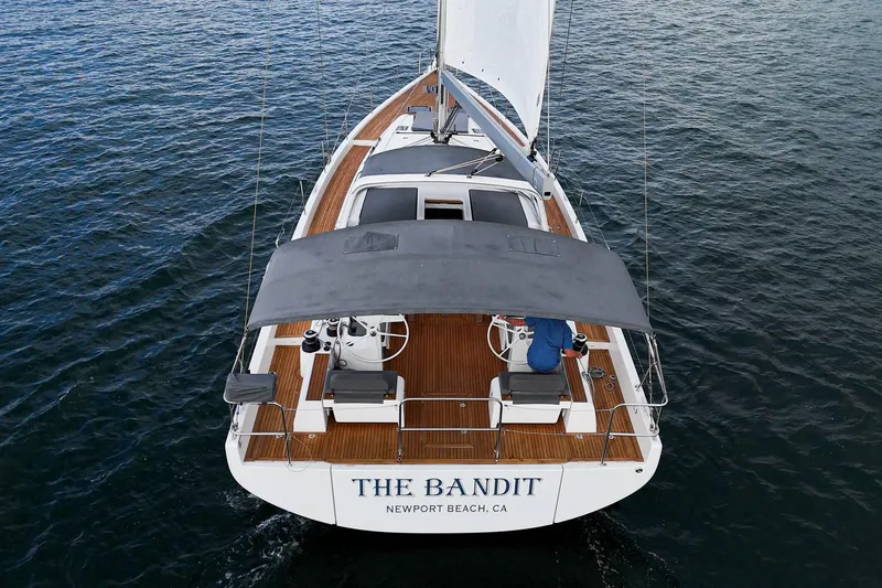 Slide: The Image of 2022 Beneteau Oceanis Yacht 54 sailing on open water, rear view. - 45