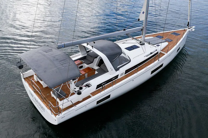 Slide: The Image of 2022 Beneteau Oceanis Yacht 54 sailing on calm waters, showcasing sleek design and spacious deck. - 46