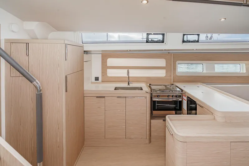 Slide: The Image of Modern kitchen interior of 2022 Beneteau Oceanis Yacht 54, featuring sleek cabinetry and appliances. - 5