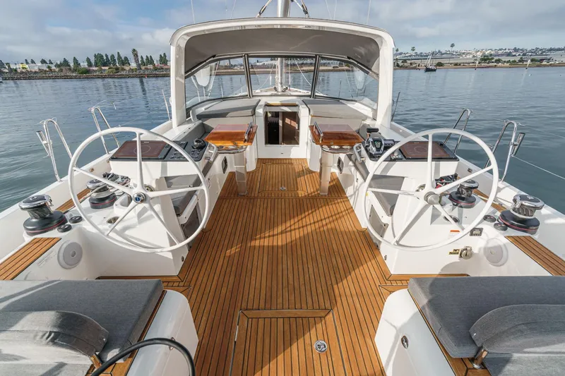 Slide: The Image of 2022 Beneteau Oceanis Yacht 54 cockpit with dual steering wheels and teak decking. - 54