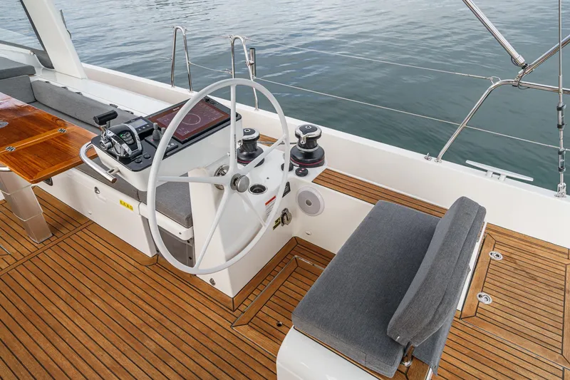 Slide: The Image of Cockpit of 2022 Beneteau Oceanis Yacht 54 with modern steering and teak flooring. - 56