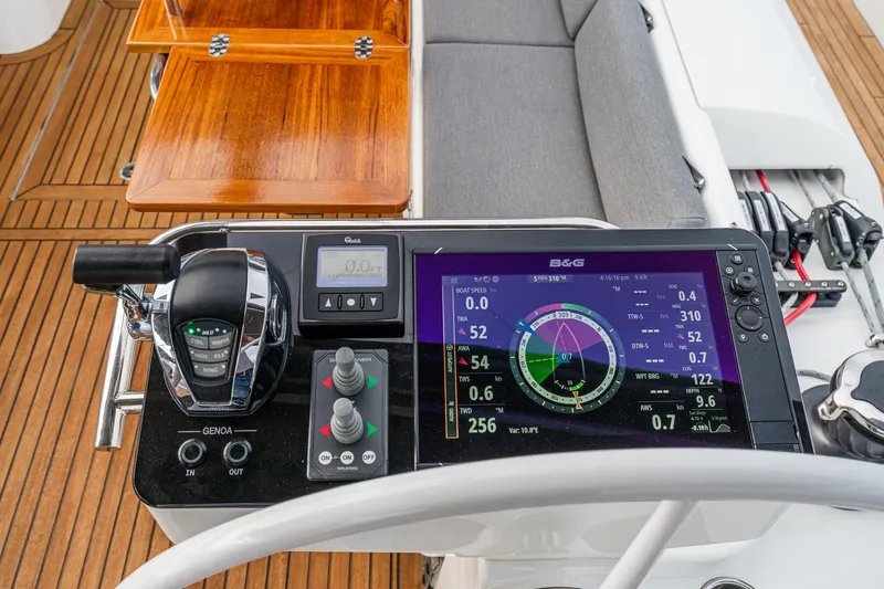 Slide: The Image of Cockpit of 2022 Beneteau Oceanis Yacht 54 with navigation controls and display. - 58