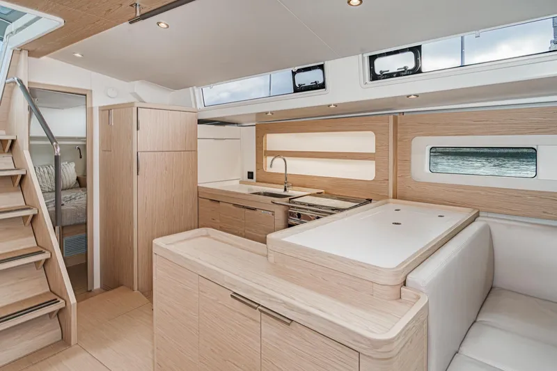 Slide: The Image of Luxurious interior of 2022 Beneteau Oceanis Yacht 54, featuring modern kitchen and seating area. - 6