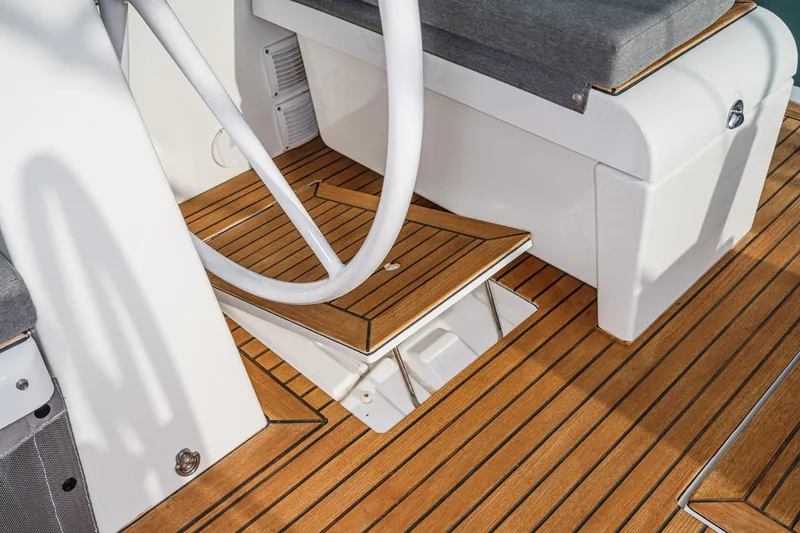 Slide: The Image of 2022 Beneteau Oceanis Yacht 54 cockpit with teak flooring and seating area. - 60